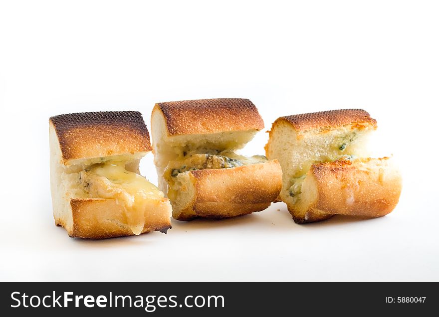 Toasted baguette melted dripping stilton blue cheese isolated on white background