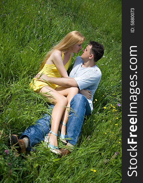 Attractive couple together on meadow in summer day