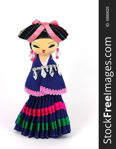 Chinese doll with ethnologic clothes on white background.