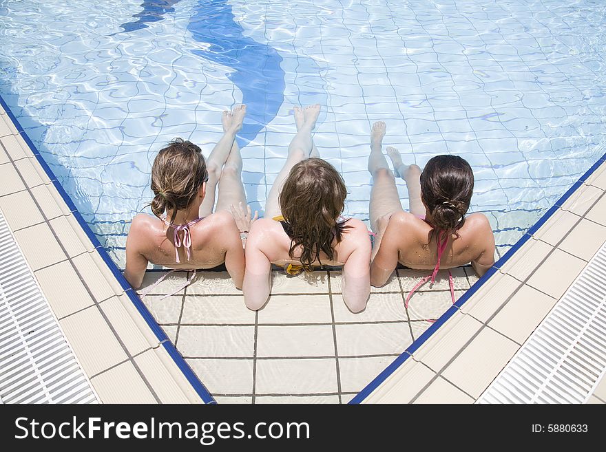 Teen girls sit in the water. Teen girls sit in the water