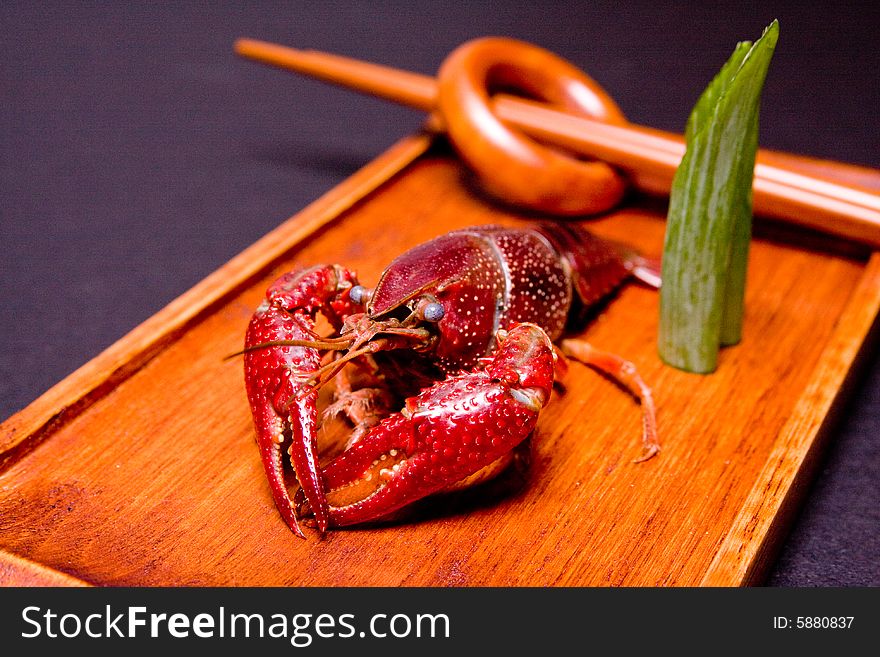 Seafood crawdads with shells in a wooden plate. Seafood crawdads with shells in a wooden plate.