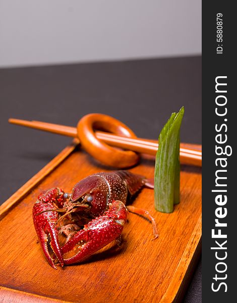 Seafood crawdads with shells in a wooden plate. Seafood crawdads with shells in a wooden plate.