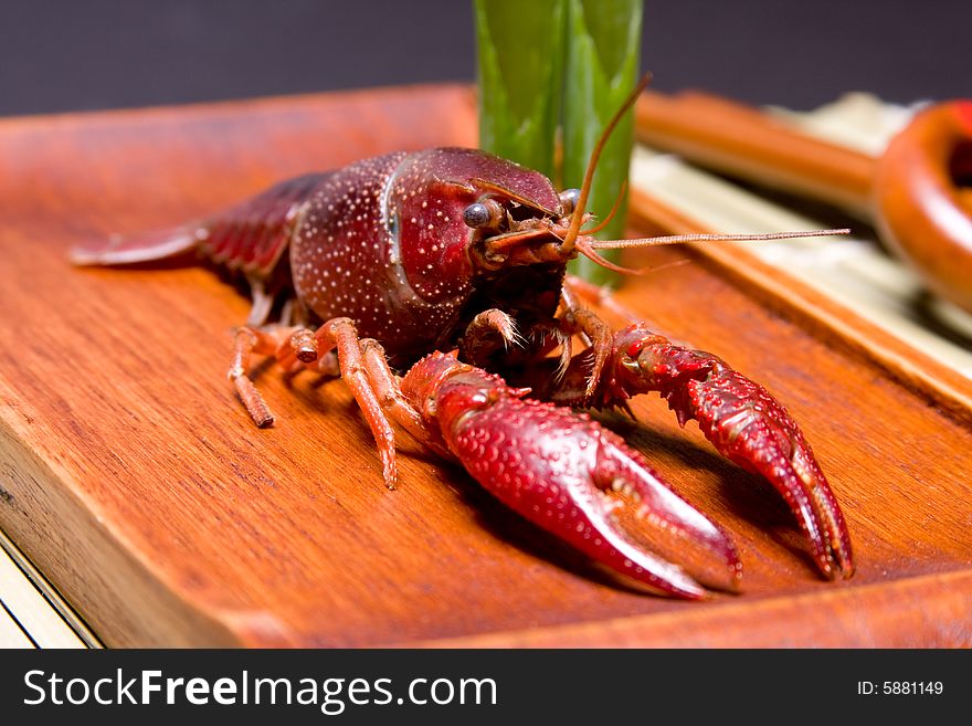 A presentation of a Seafood crawdads in a wooden plate. A presentation of a Seafood crawdads in a wooden plate.