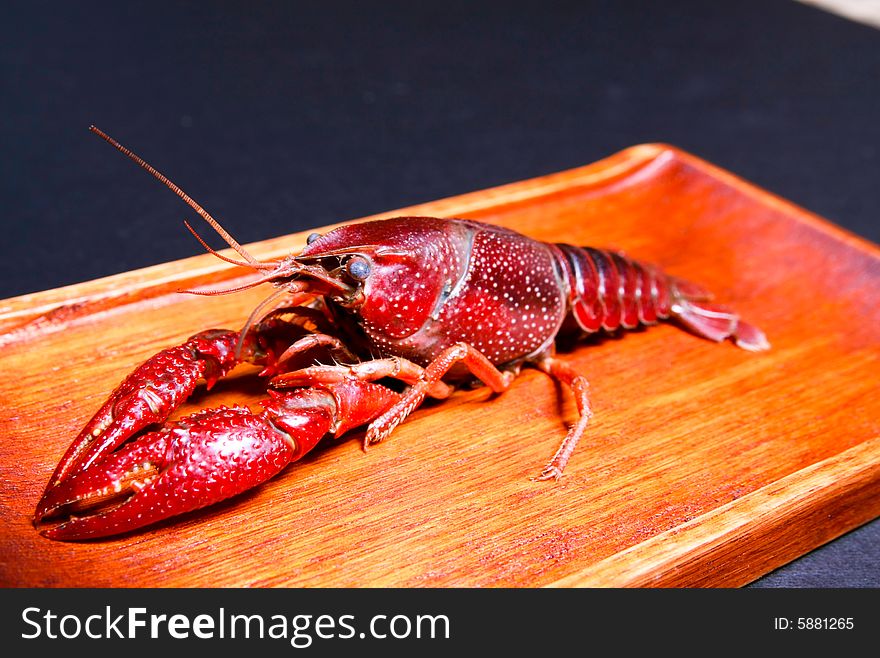 Seafood crawdads in a wooden plate positioned sideways. Seafood crawdads in a wooden plate positioned sideways.