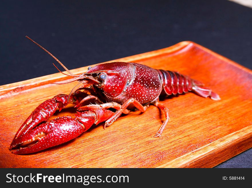 Seafood crawdads in a wooden plate.