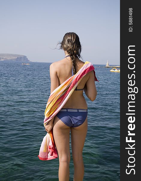 Teen girl in bikini with color towel