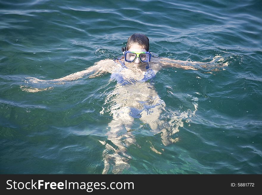 Teen girl in the water with goggles