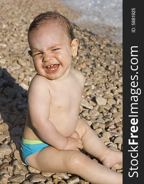 Small boy smiling on the beach. Small boy smiling on the beach