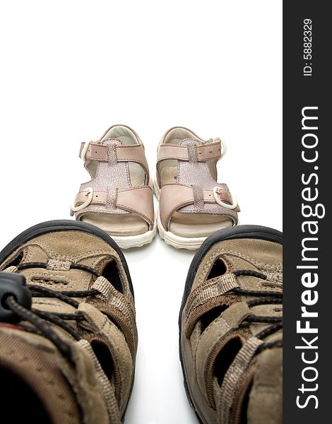 Big male and small baby walking sandals, isolated, on white background. Big male and small baby walking sandals, isolated, on white background