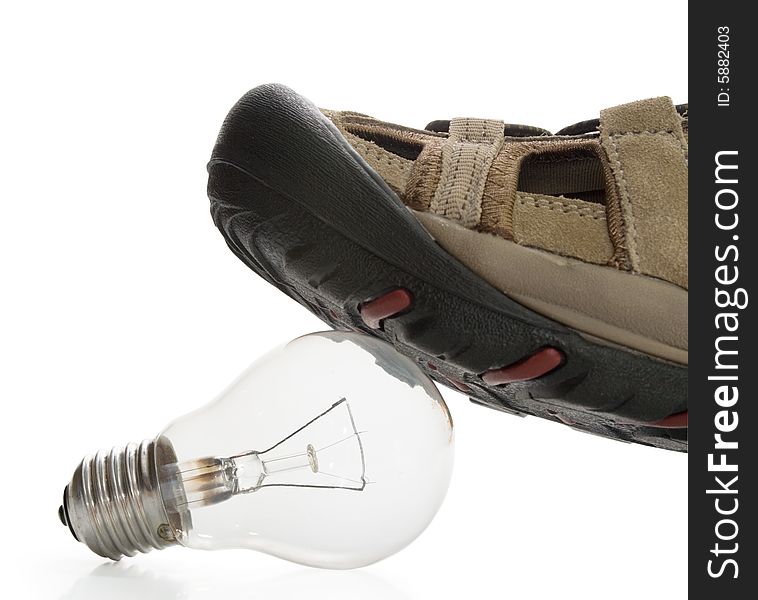 Man shoe steeping and crushing the bulb, side view
