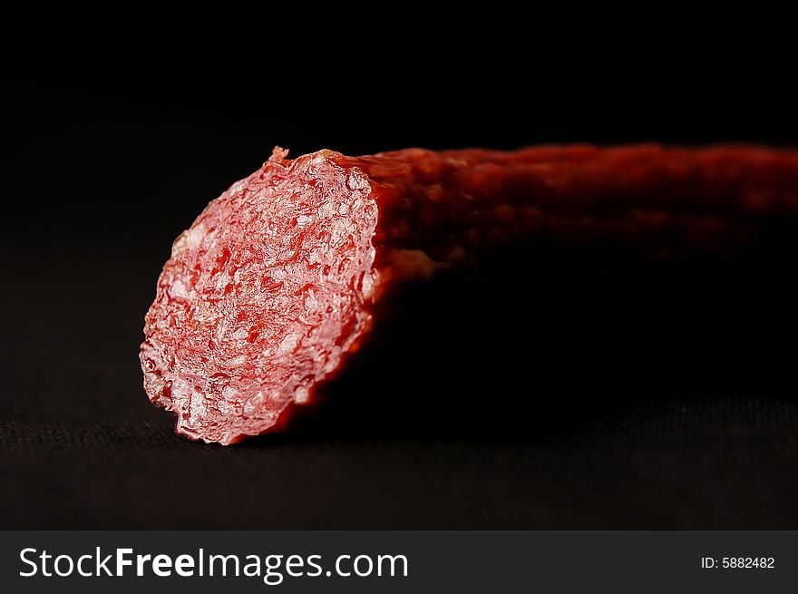 Appetizing sausage on a dark background