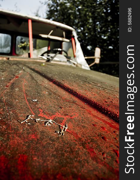 Red car at a junk yard