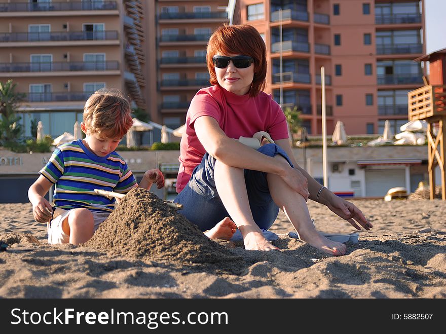 Mother and the son have a rest on a beach