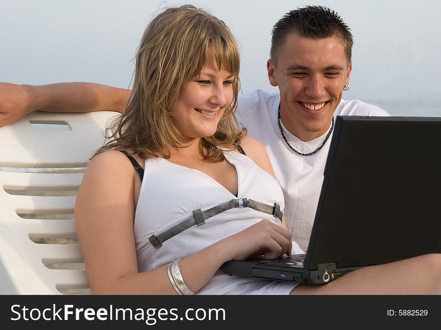 The man and the woman have a rest on coast of ocean. The man and the woman have a rest on coast of ocean