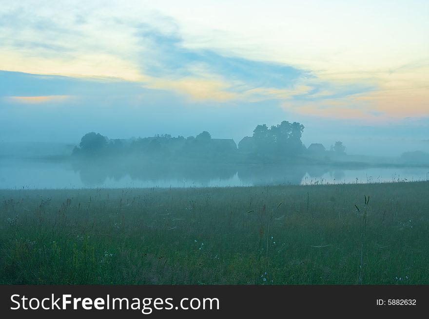 Fog lifts over the farm, lake and meadow. Fog lifts over the farm, lake and meadow.