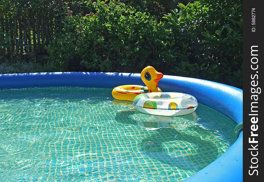 Waterpool with toys in the garden