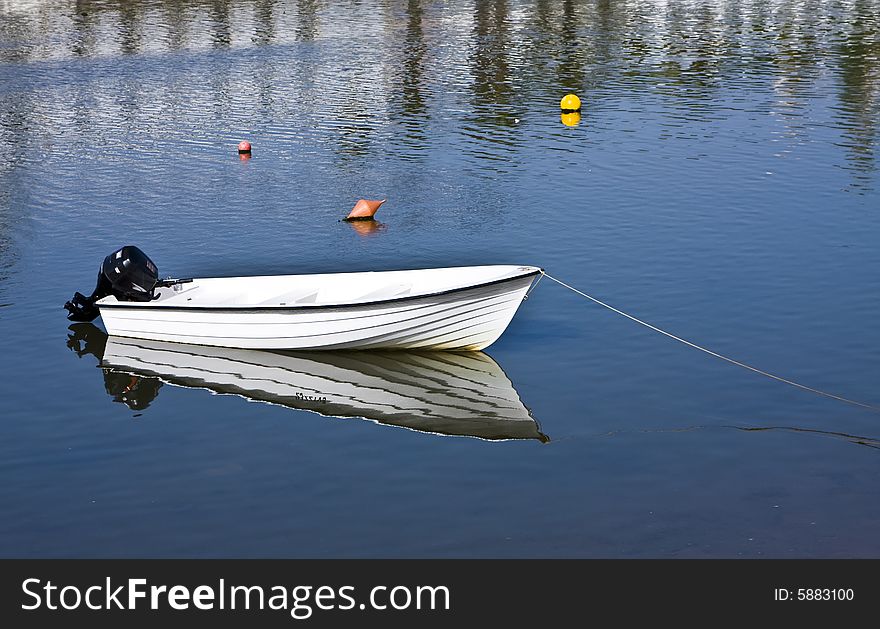 Small fishing boat with beautiful reflection.