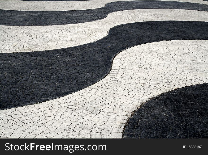 Wavy black and white paved roadway. Wavy black and white paved roadway