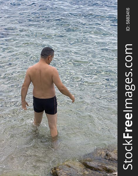 Man going for a swim in sea