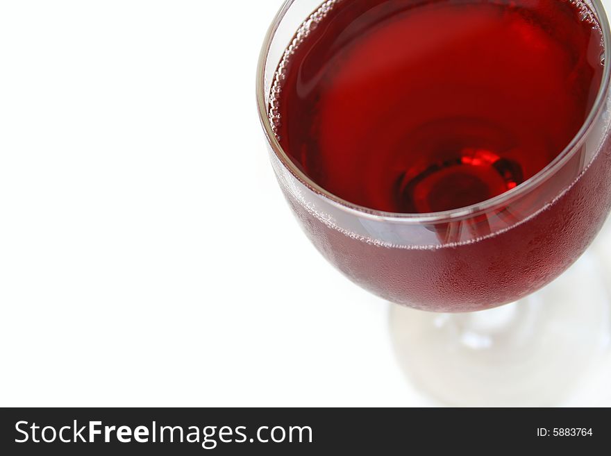 Red wine, macro view with focus on both sides of the lip of glass and very front of glass. Isolated on white with copy space.