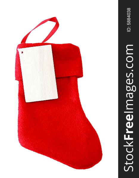 A red Christmas stocking with a blank name tag all isolated on a white background.