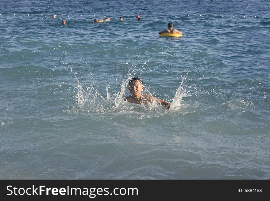 Happy boy playing in a water