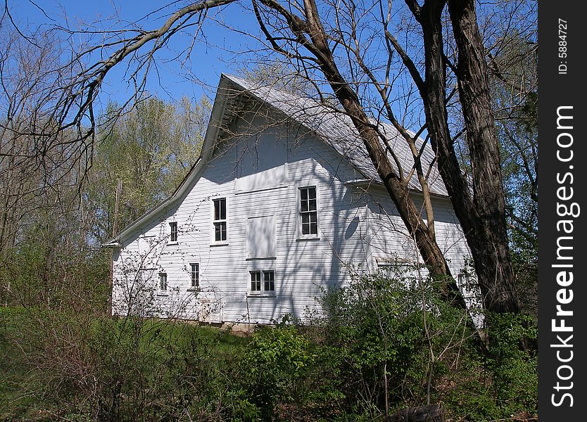 Barn surrounded by foliage & shrubbery. Barn surrounded by foliage & shrubbery.