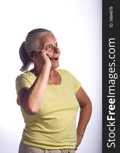 Senior woman on phone looking surprised and happy. Senior woman on phone looking surprised and happy