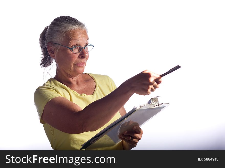 Senior woman marking clipboard,wearing glasses. Senior woman marking clipboard,wearing glasses