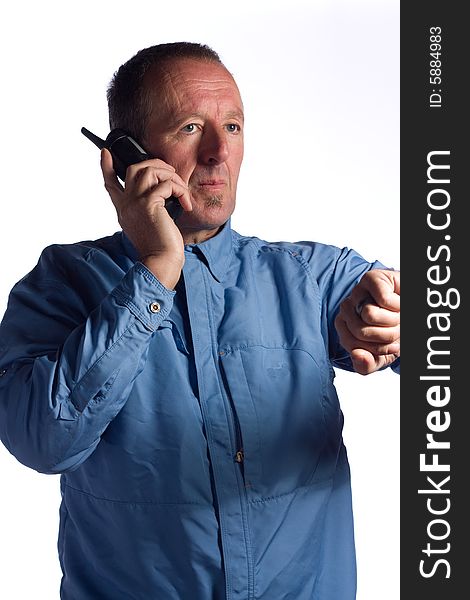 Senior man listening to phone looking off into distance. Senior man listening to phone looking off into distance