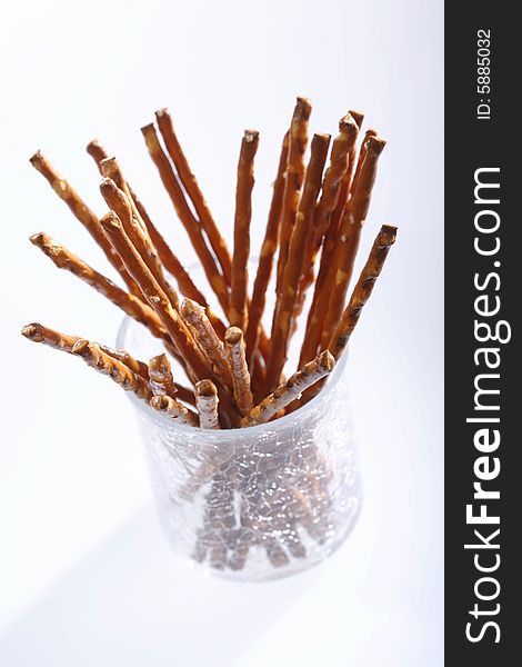 Saltsticks in a glass on white background