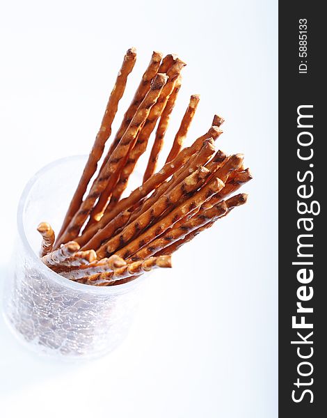 Saltsticks in a glass on white background