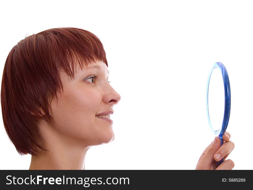 Portrait of the red-haired girl with a mirror in a high key. Portrait of the red-haired girl with a mirror in a high key.