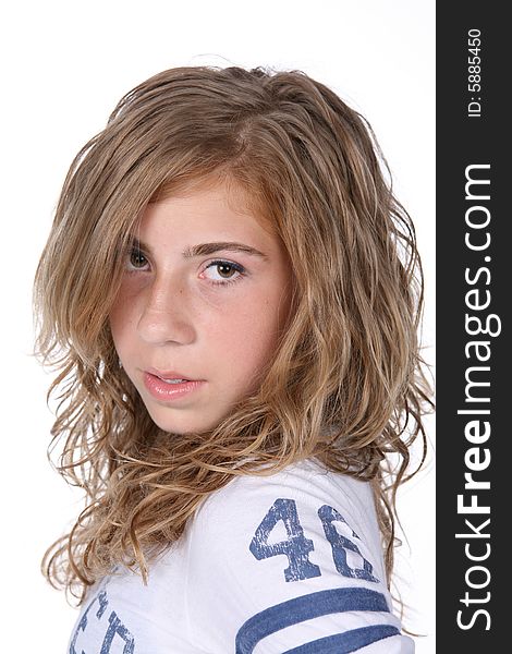 Pre-teen girl with curly hair and sports jersey