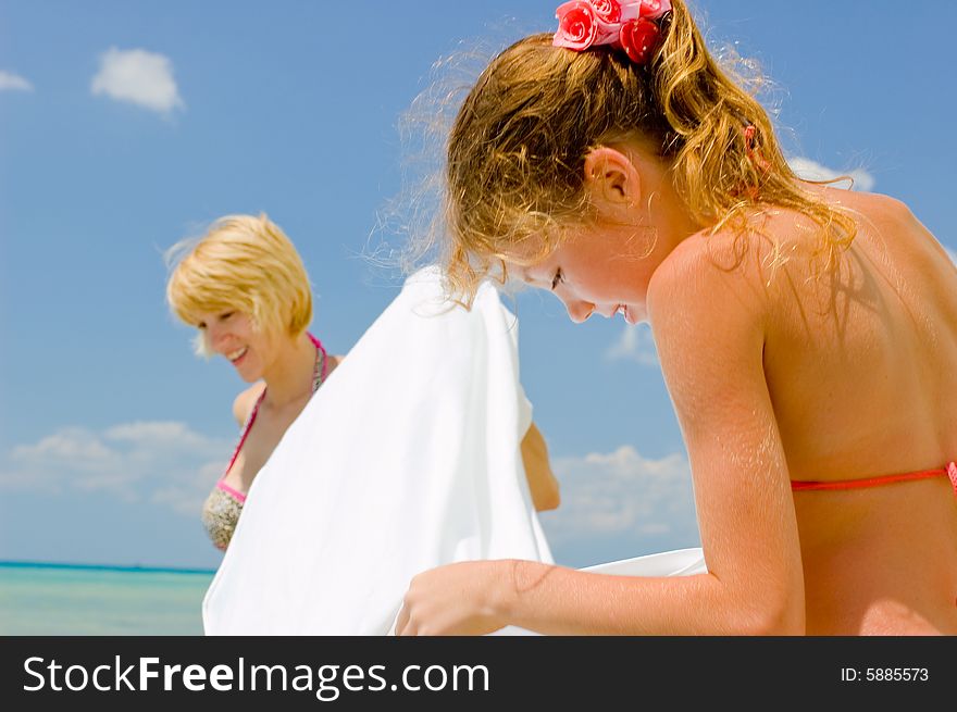 Mother and daughter having fun on the beach