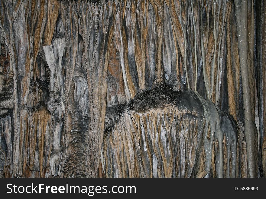 Stone background: stalactites at the cave