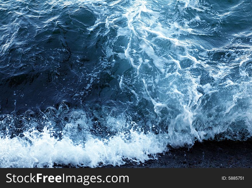 An image of a wave in blue sea. An image of a wave in blue sea