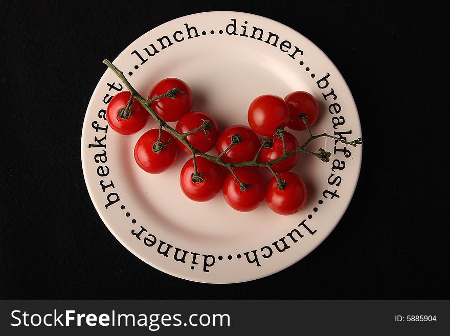 Red cherry tomatoes on the plate