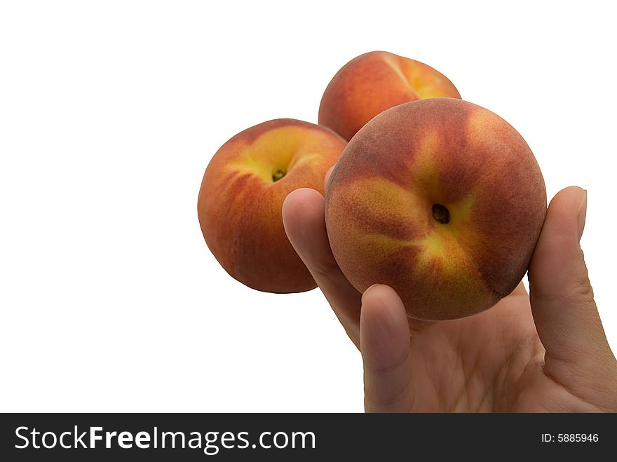 Two peach and one peach in a hand. Two peach and one peach in a hand
