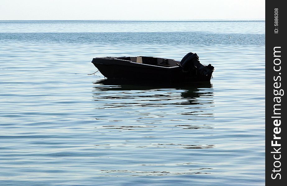 The empty boat in calm waters of Caribbean Sea. The empty boat in calm waters of Caribbean Sea.