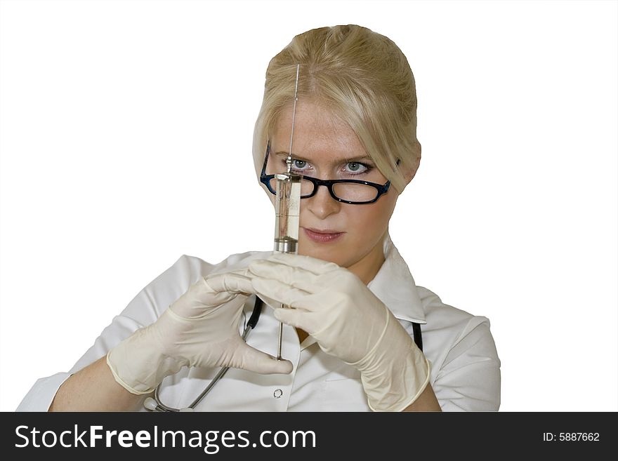 A young female doctor/nurse is looking straight at the syringe needle isolated on the white background. A young female doctor/nurse is looking straight at the syringe needle isolated on the white background