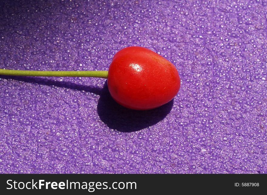 Detail of cherry on violet background