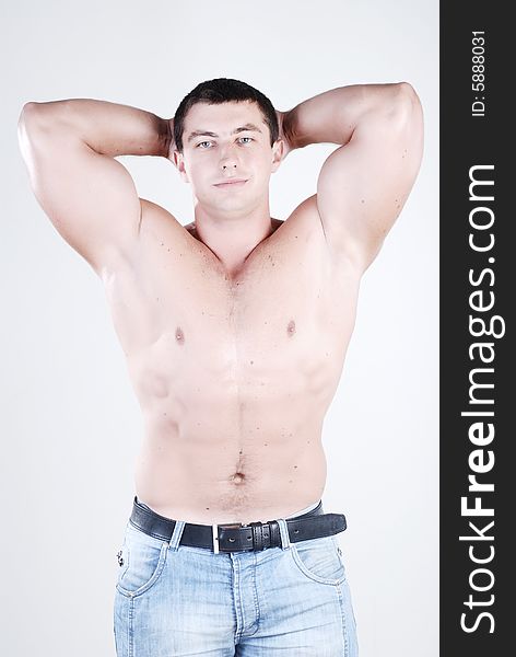 Young man athlete with perfect body at white background. Young man athlete with perfect body at white background