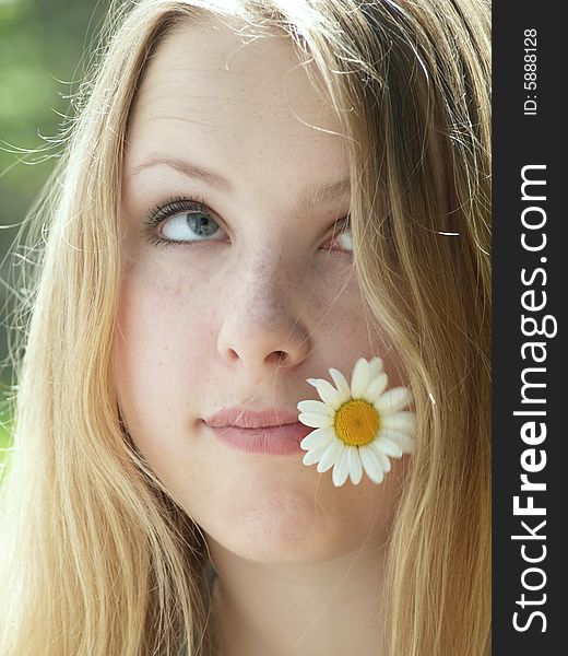 Expressive face of a model with flower in her mouth. Expressive face of a model with flower in her mouth