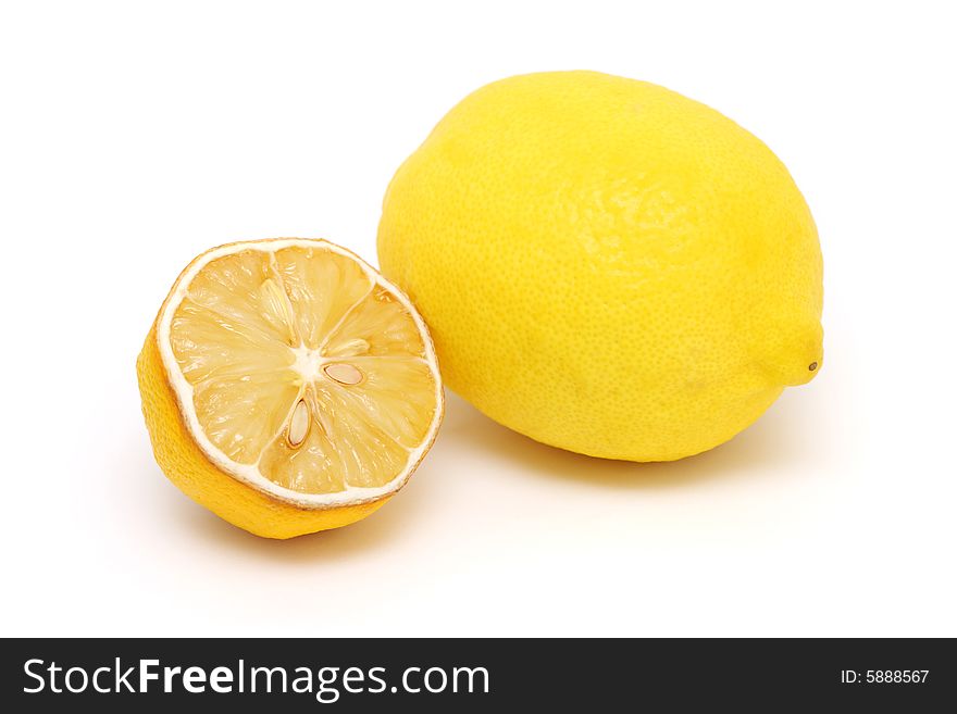 A dried half lemon and the fresh one on white background. A dried half lemon and the fresh one on white background.