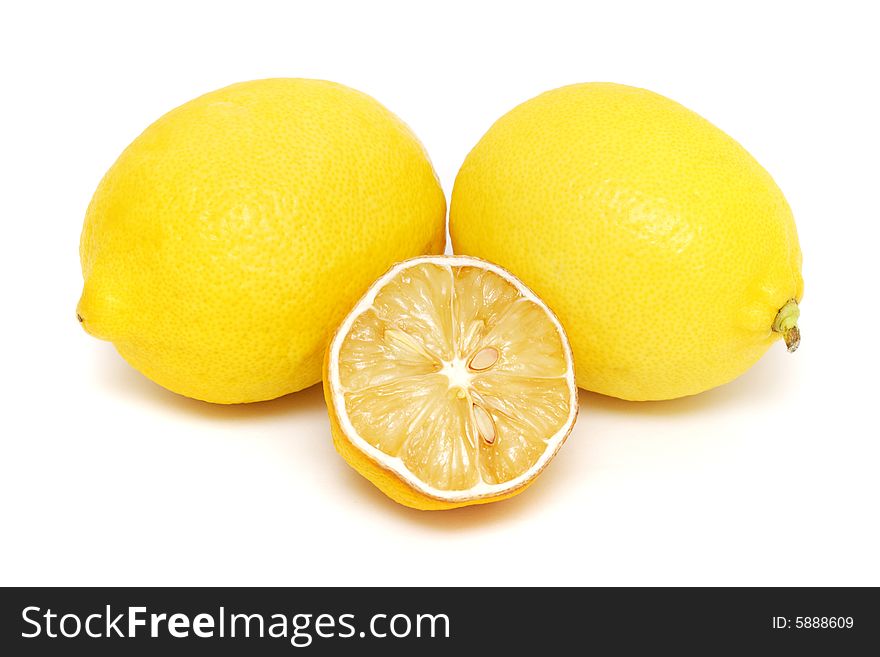 Half dried lemon put together with two fresh lemons on white background.