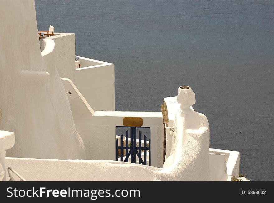 Whitewashed walls against the blue water of the Caldera, Ia, Santorini. Whitewashed walls against the blue water of the Caldera, Ia, Santorini.