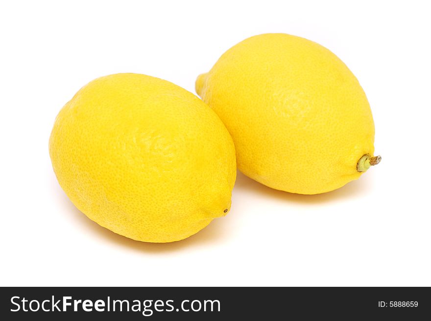 Two fresh yellow lemons isolated on white background.