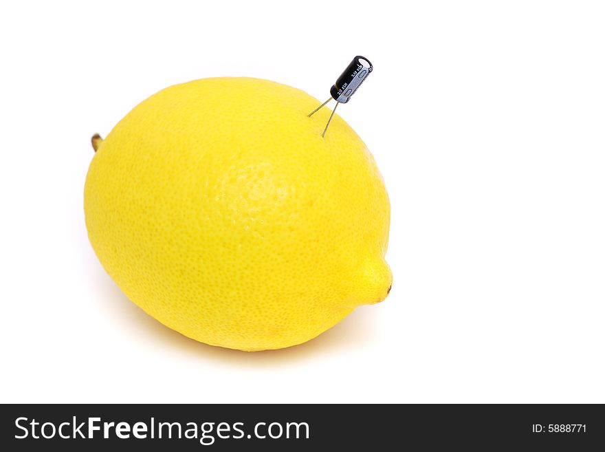 A capacitor plug on fresh lemon over white background. A capacitor plug on fresh lemon over white background.