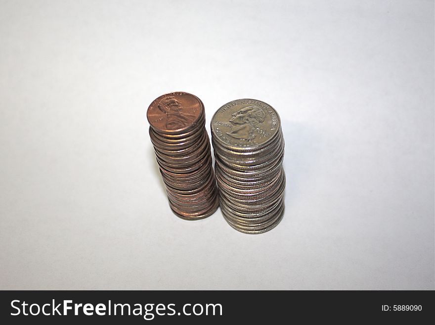 Quarters and pennies, stacked high with white background. Quarters and pennies, stacked high with white background.